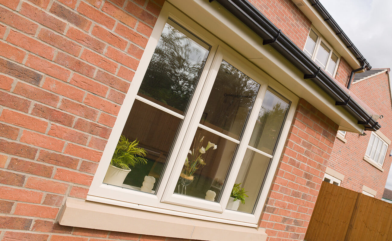 cream casement windows on a brick house