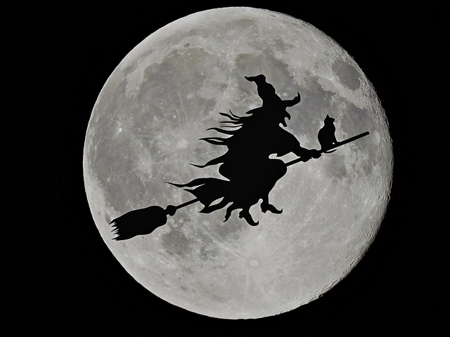 black witch figure with moon