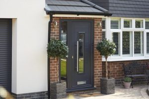 A picture containing building, porch, stone, and door with pull bar