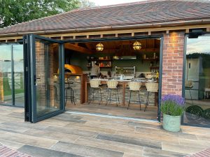 exterior shot of open aluminium doors looking into country house