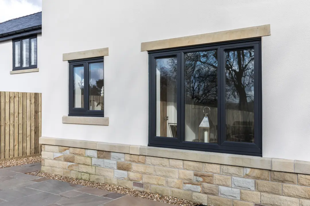 Black flush sash uPVC windows on a modern rendered property in Blackburn